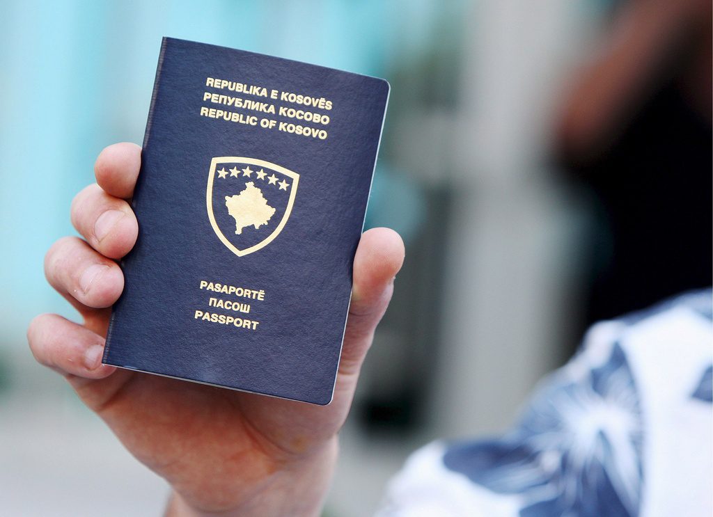 A Kosovar Albanian man shows his newly issued Kosovo passport in Kosovo's capital Pristina